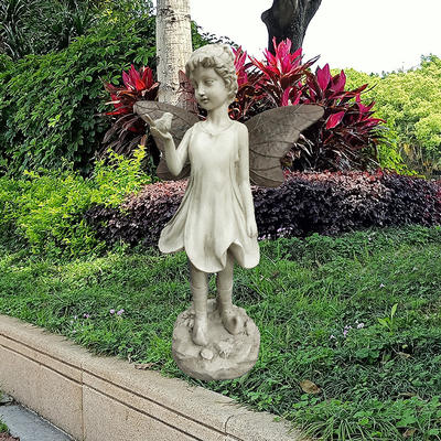 Dainty fairy holding bird with metal wings garden statue ornament