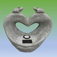 Solar powered spot light on heart shaped statue with pair frogs on top for garden decoration