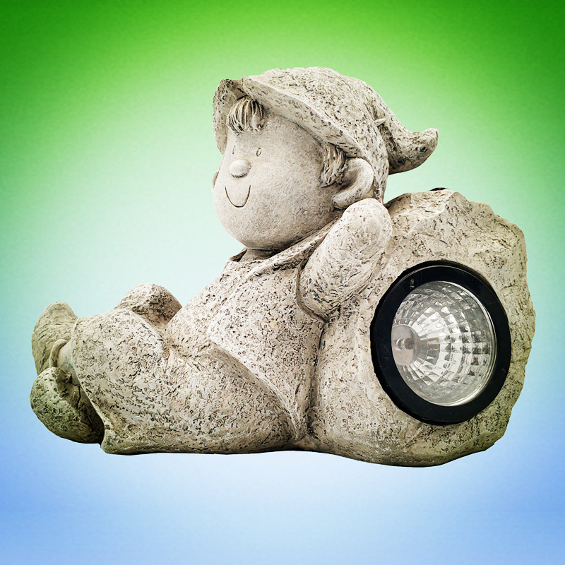 Personalized outdoor decoration little boy statue resin boy relaxing on stone with solar spotlight for sale